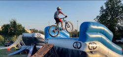 Biker performing a stunt over an inflatable slide