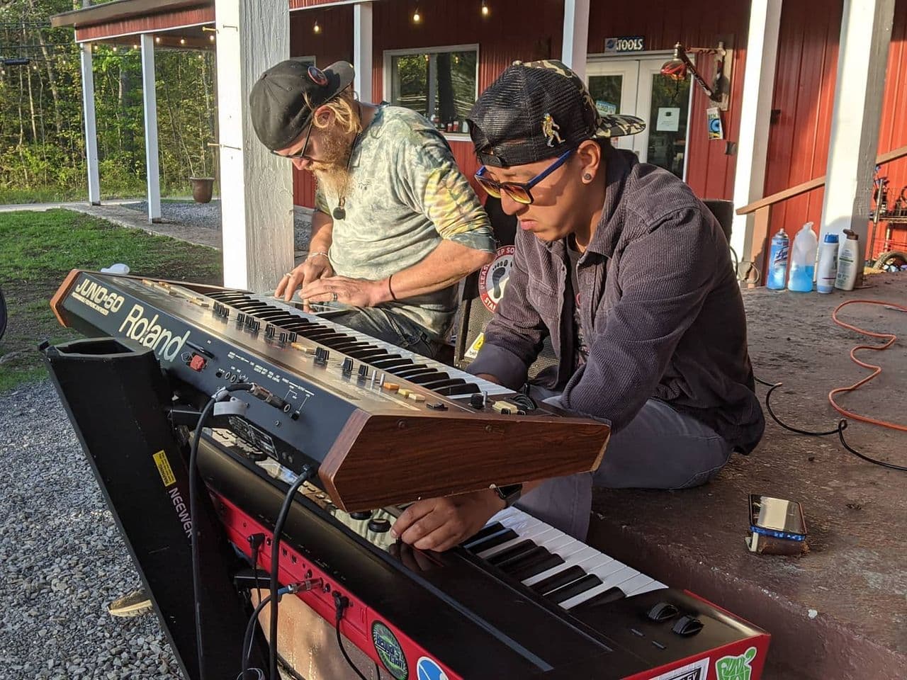 two men behind an electric keyboard