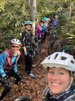 Group of women riding bikes in the woods